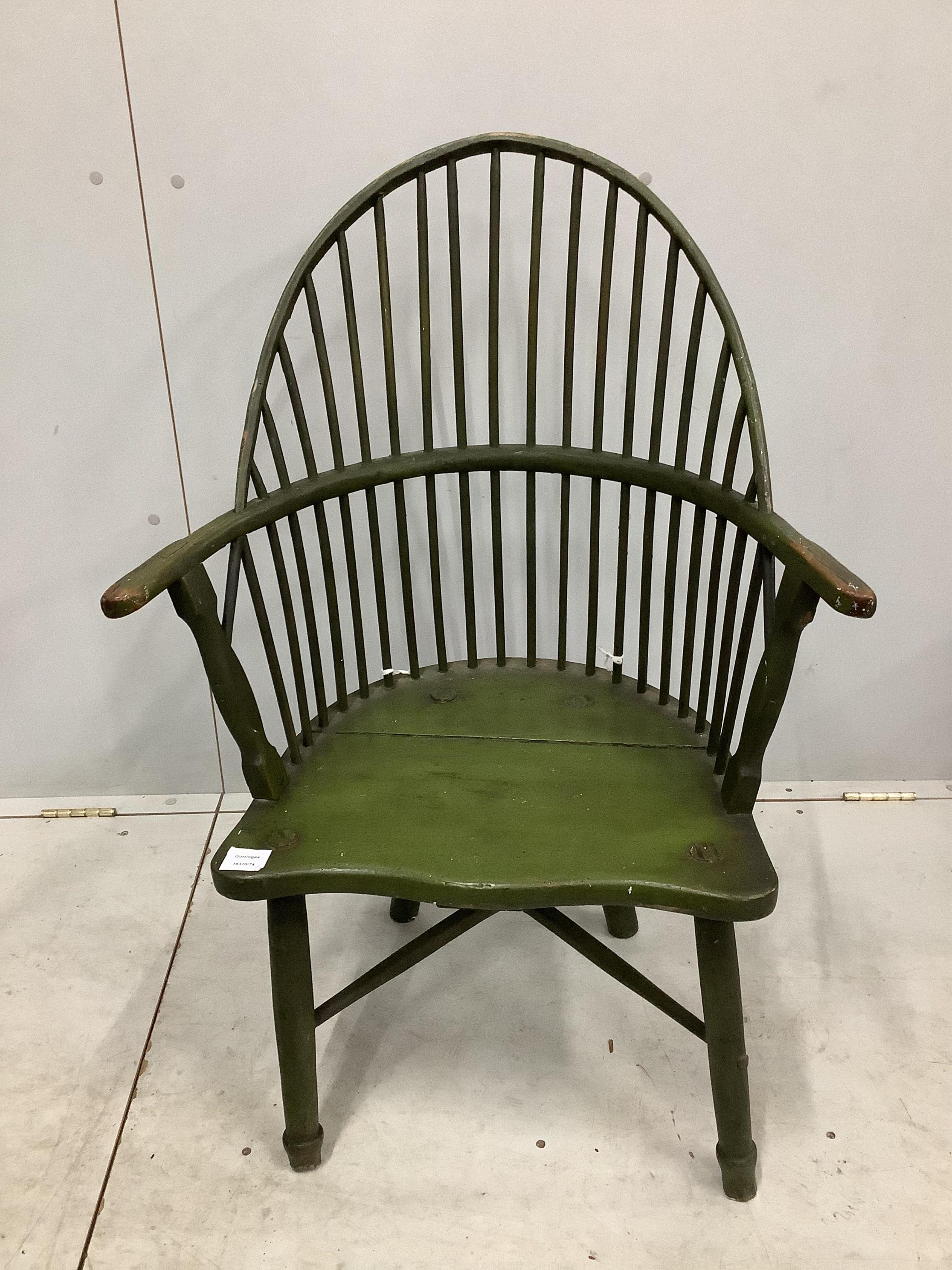 An early 19th century primitive arched stick back elbow chair, width 66cm, depth 43cm, height 95cm. Condition - poor to fair